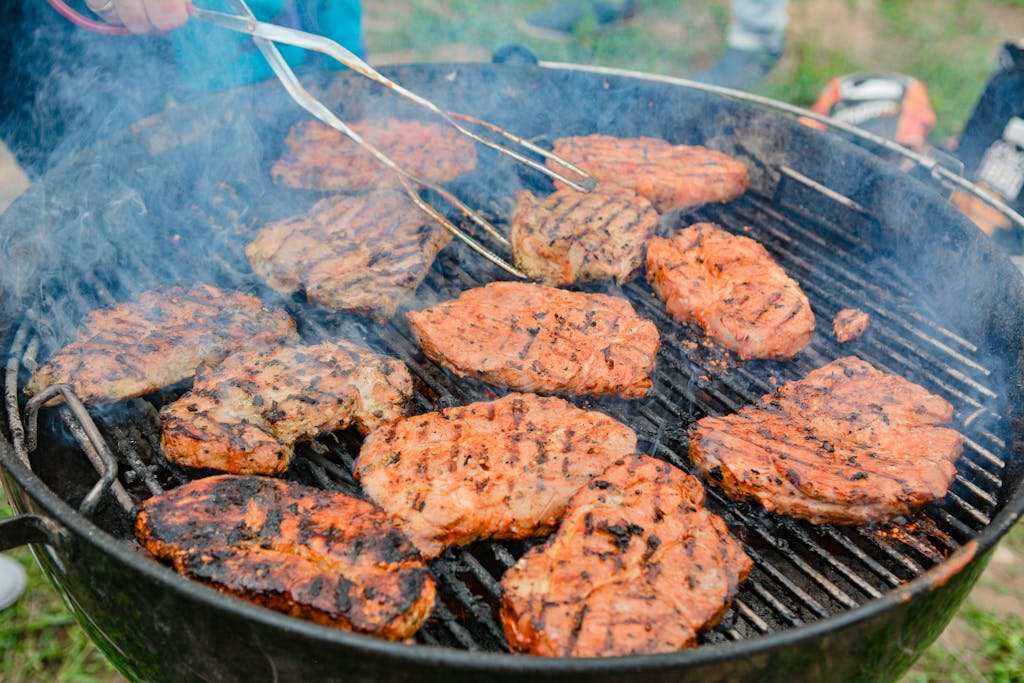 Grilling mouthwatering pork chops outdoors, showcasing delicious BBQ flavors.
